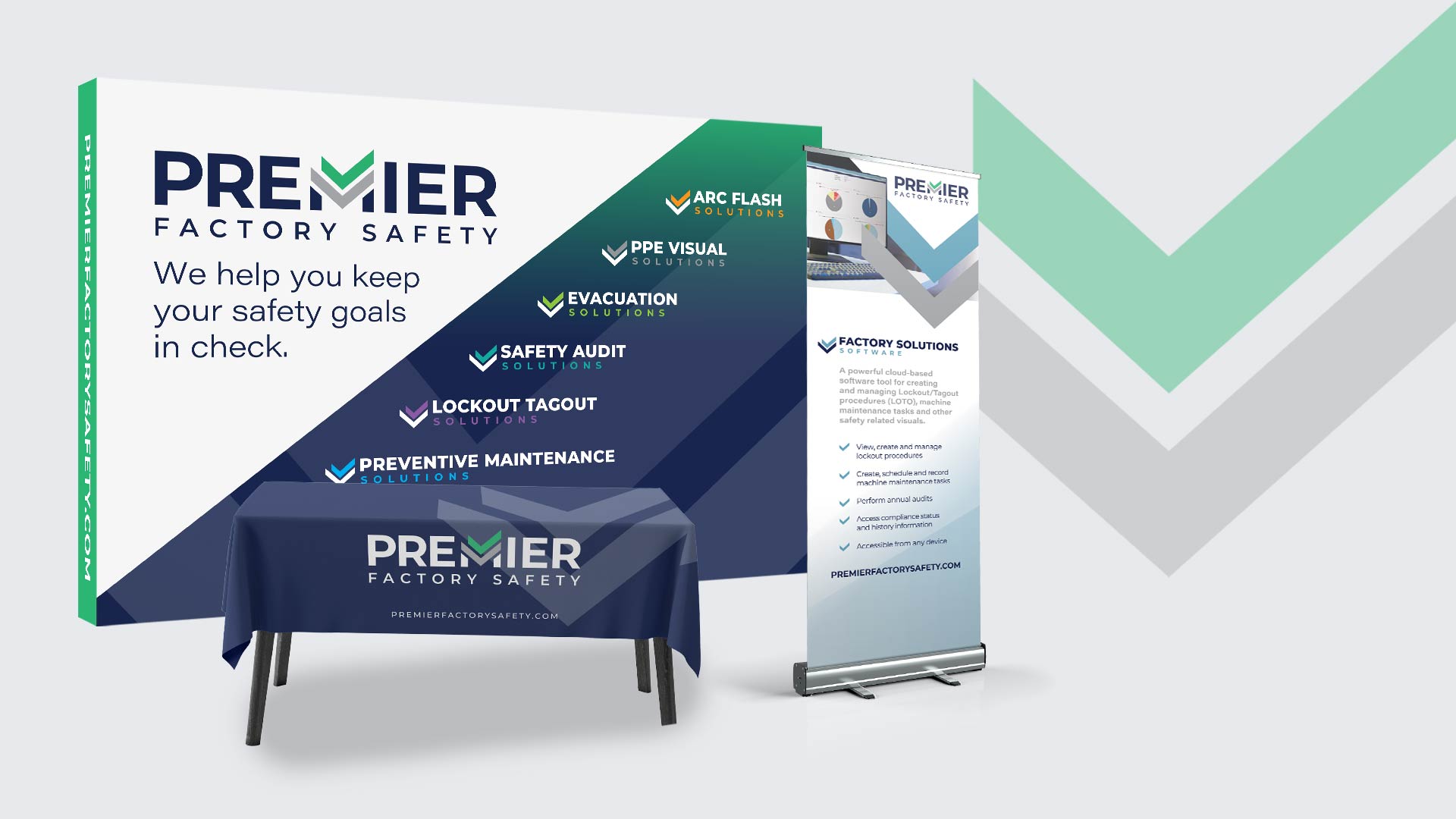 Display of Premier Factory Safety materials includes a branded wall, a table with a tablecloth, and a standee detailing safety solutions like PPE, audits, and maintenance.