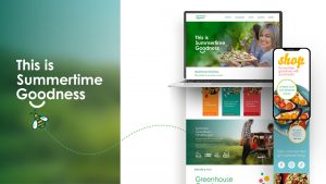 A laptop and smartphone display a website with the text "This is Summertime Goodness," featuring images of people, summer foods, and green-themed branding.