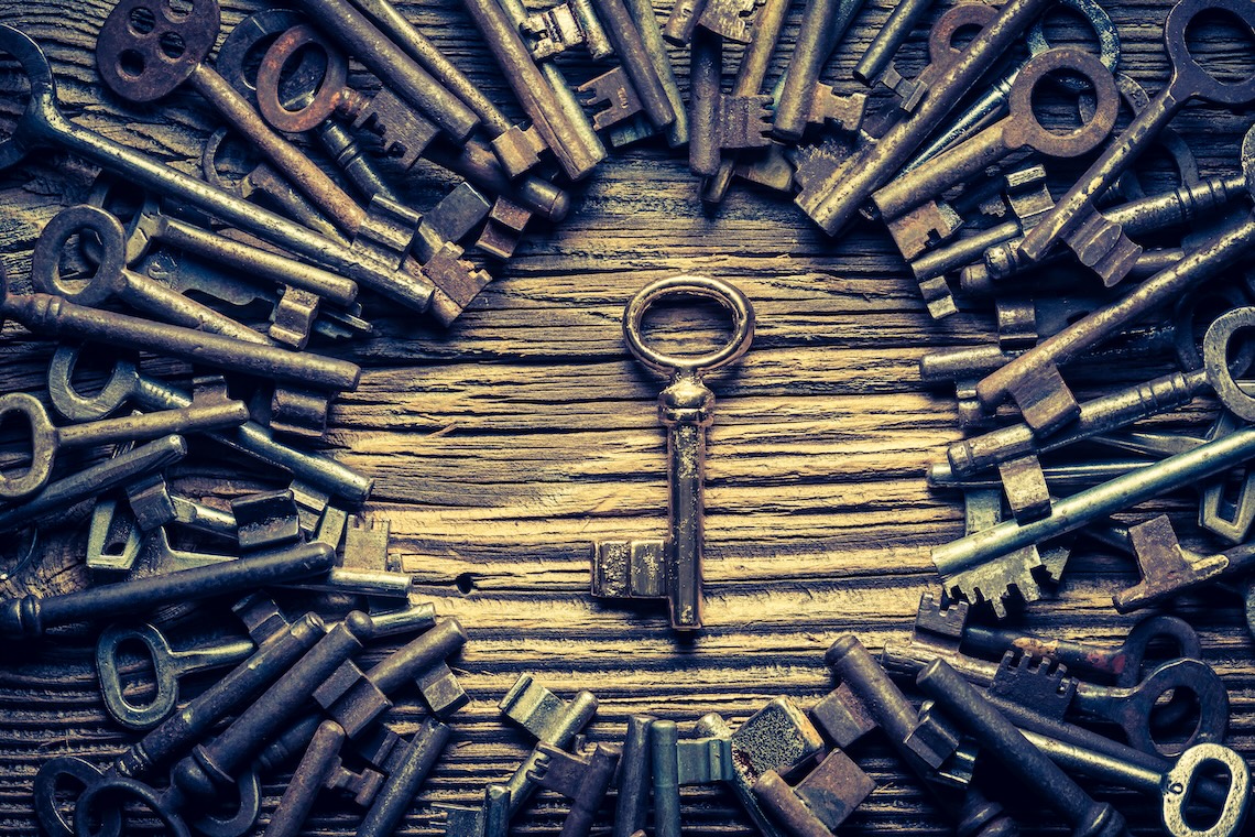 A central golden key surrounded by multiple scattered silver keys, symbolizing standout marketing insights among many possibilities for 2025.