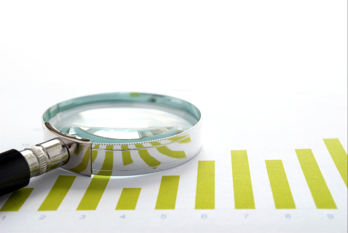 Magnifying glass symbolizing close evaluation of campaign ROI versus vanity metrics.